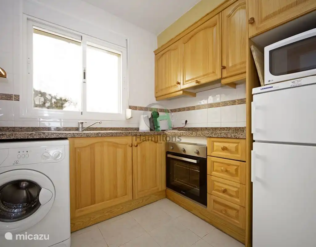kitchen with washing machine, refrigerator, microwave, oven, coffee maker, kettle, complete 