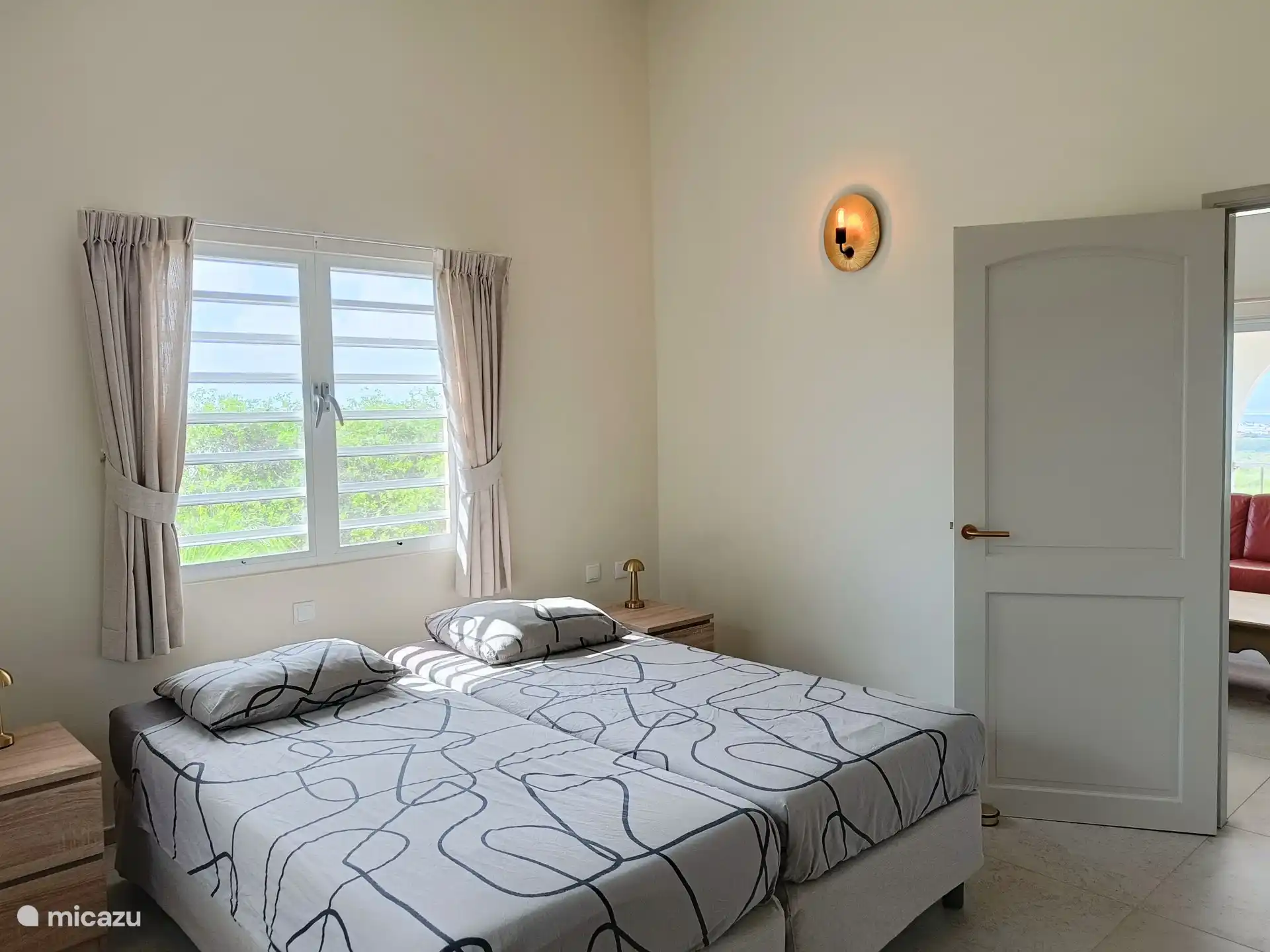 Bedroom with 2 box springs and large walk-in closet, air conditioning and ceiling fan