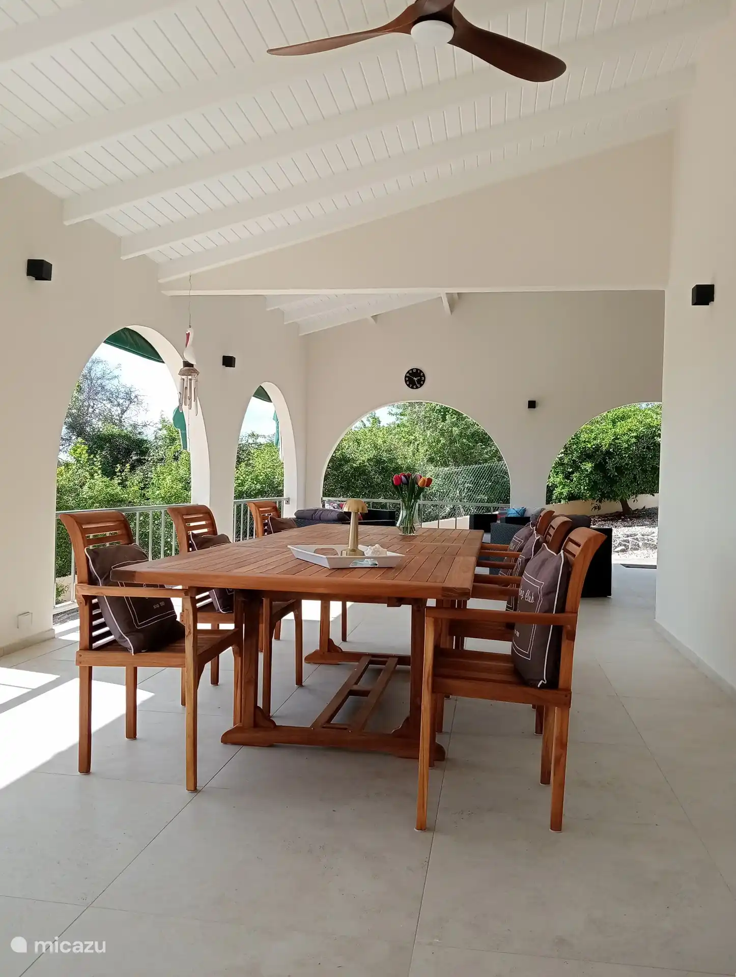 The porch with 3 lovely places to sit.