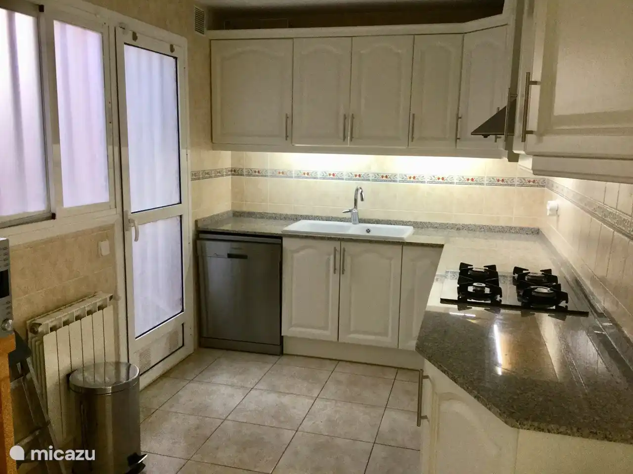 A spacious kitchen with dishwasher, combi-microwave, large fridge with freezer