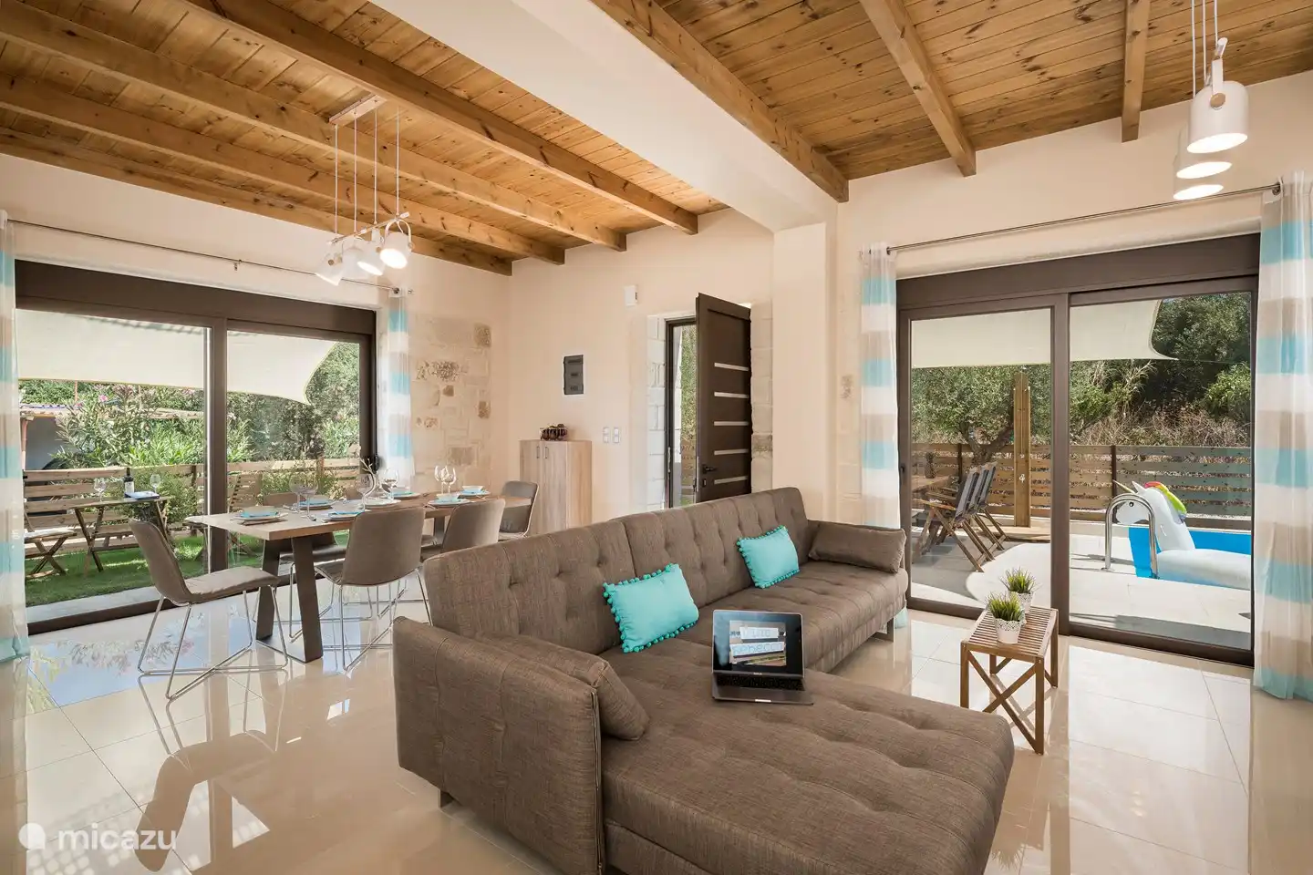 In the living and open kitchen two wonderful large sliding doors with shutters.