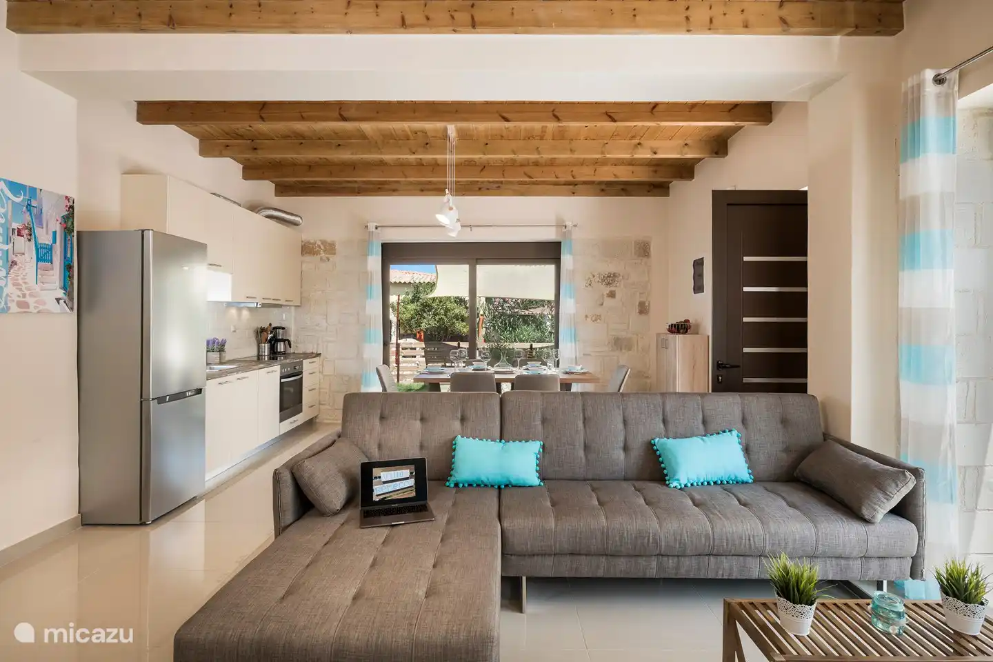 The large sofa in the living room can possibly be used as a sofa bed for 2 children.