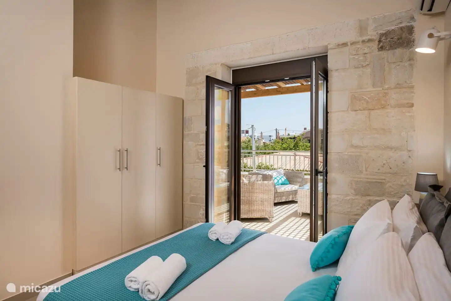 The spacious bedroom has large wardrobes and the beautiful large balcony.