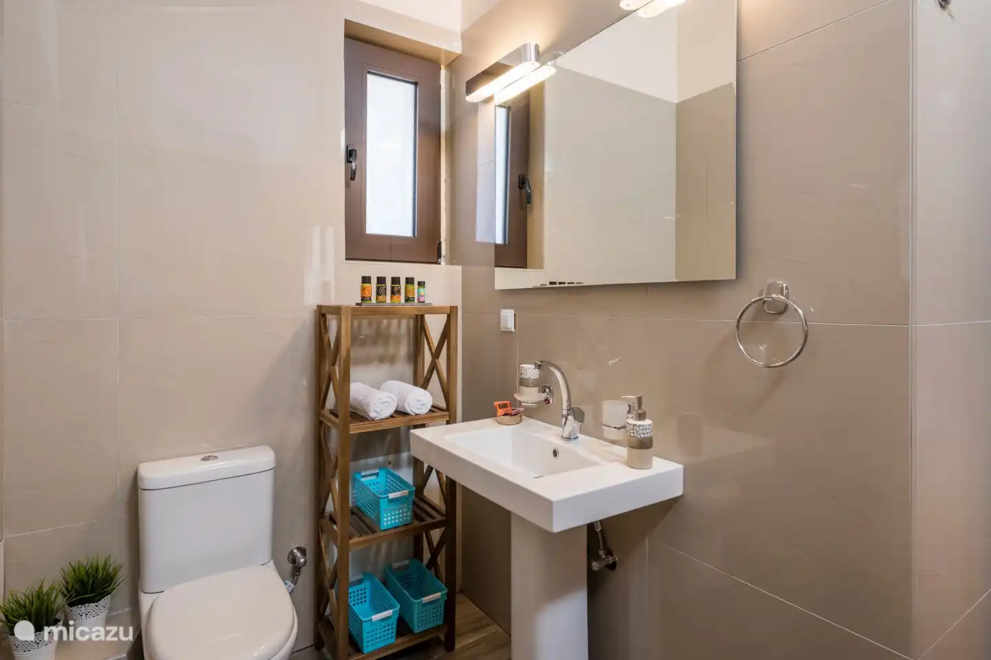 The upstairs bathroom has a toilet, sink and shower.