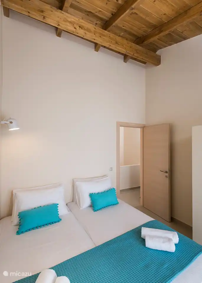 Bedroom 2 with the beautiful wooden ceiling with beams.