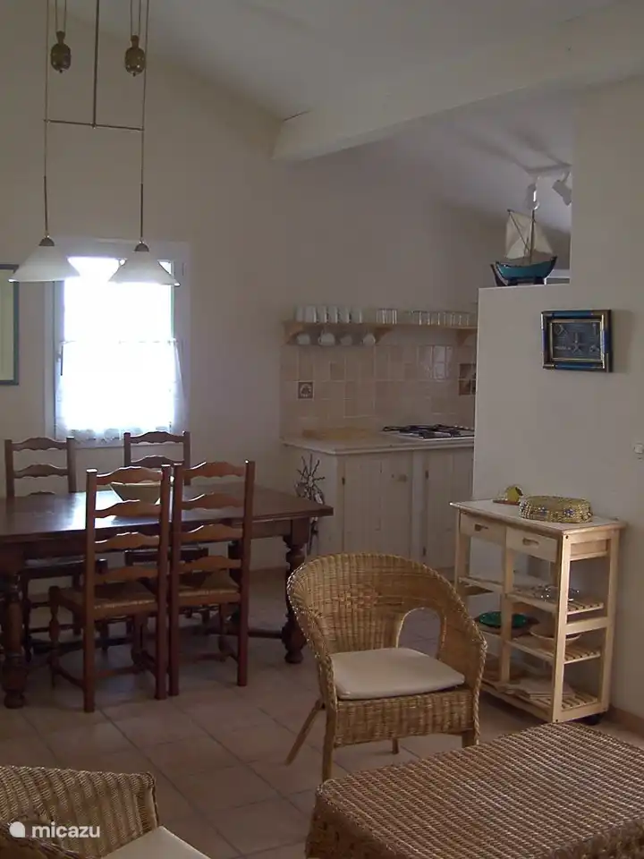 De glazen schuifdeur naar de tuin bevindt zich achter de zithoek.