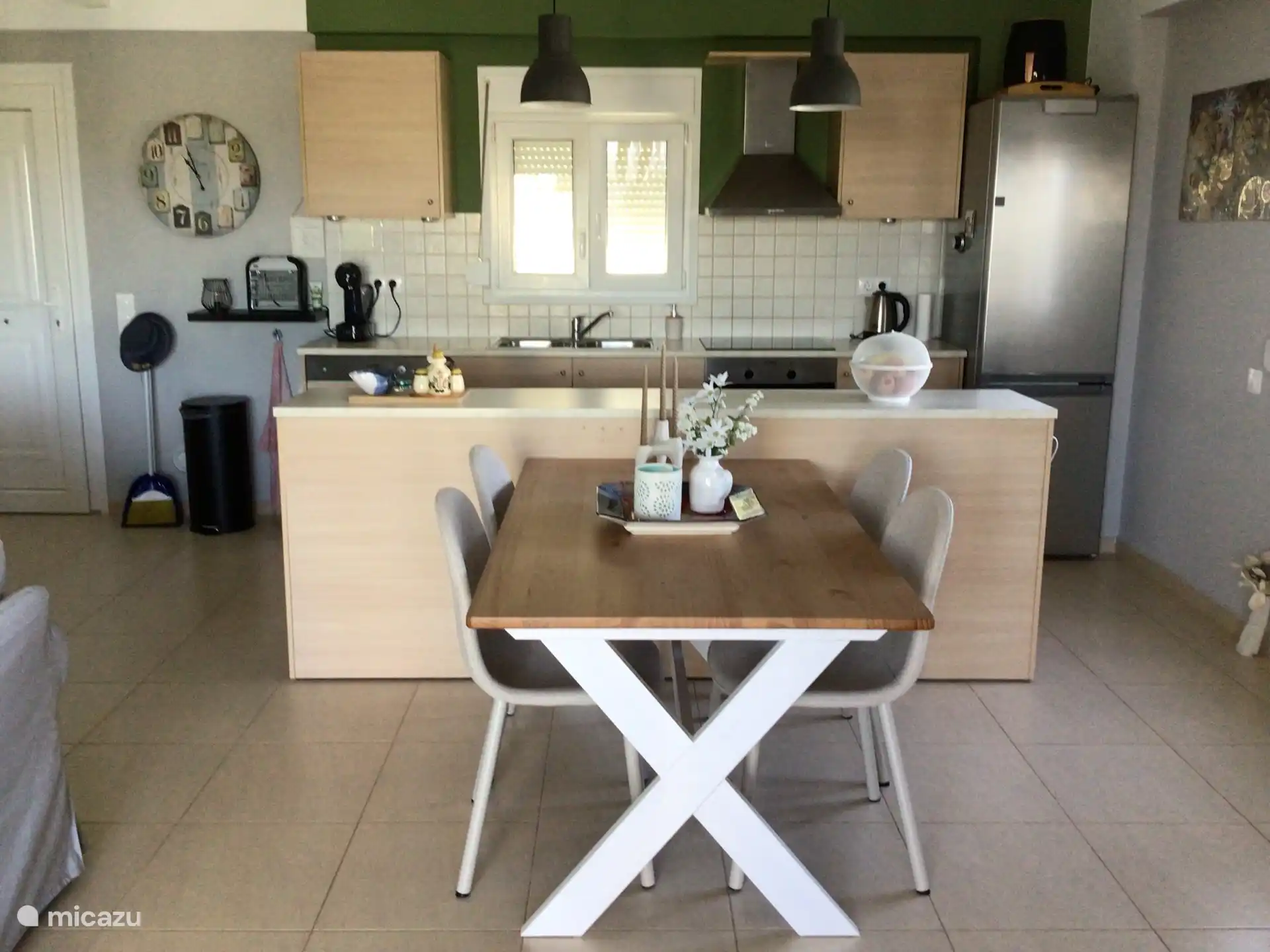 Open kitchen with bar with extra sockets and large dining area.