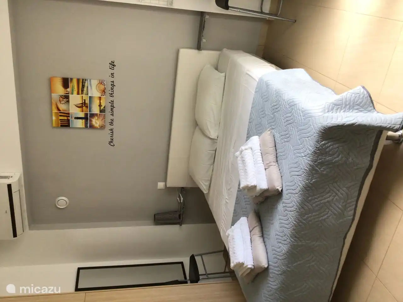 Bedroom 1 with air conditioning, full-length mirror, double bed and large closet.