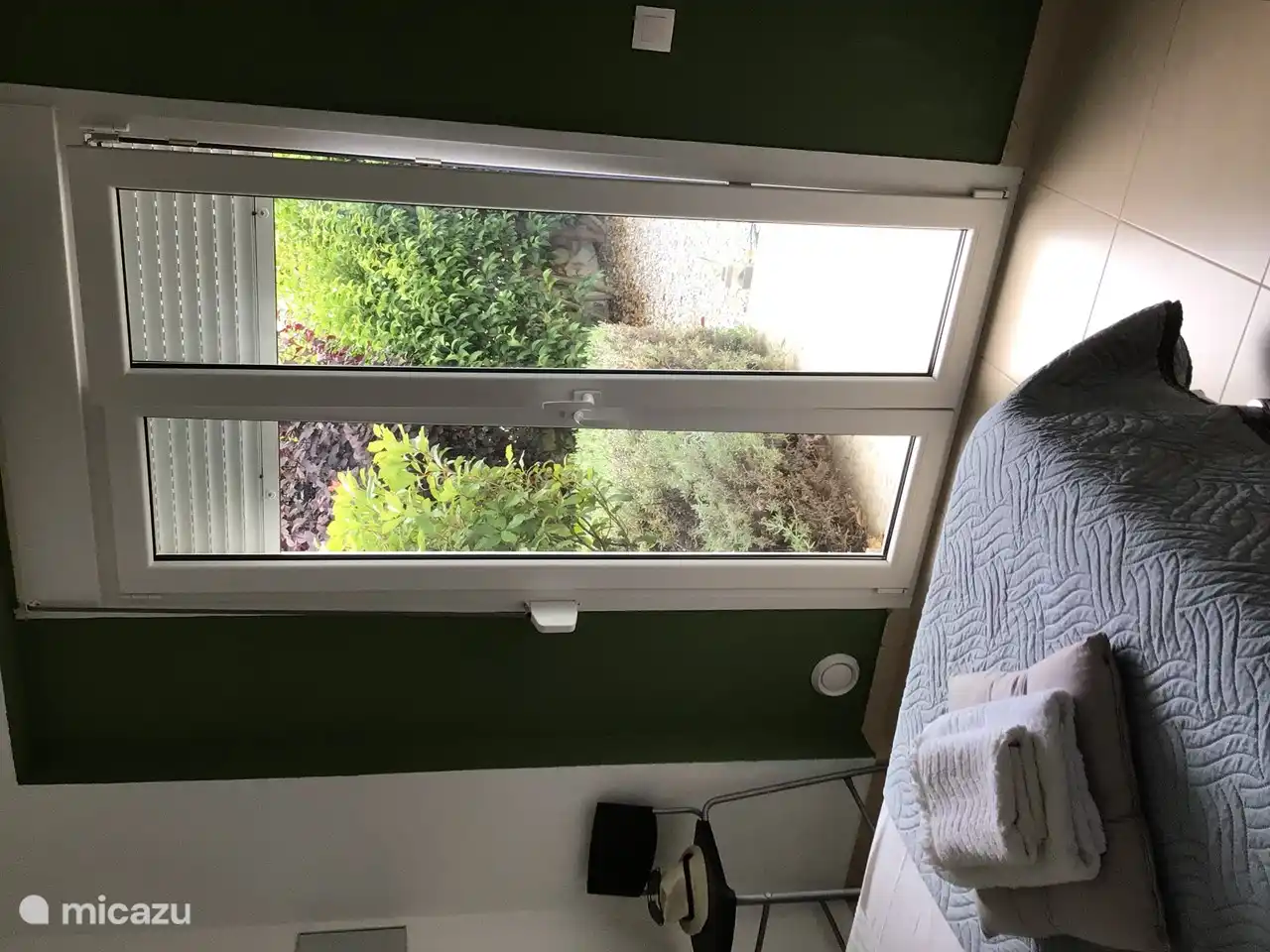 Bedroom 1 has patio doors to the garden with shutters.