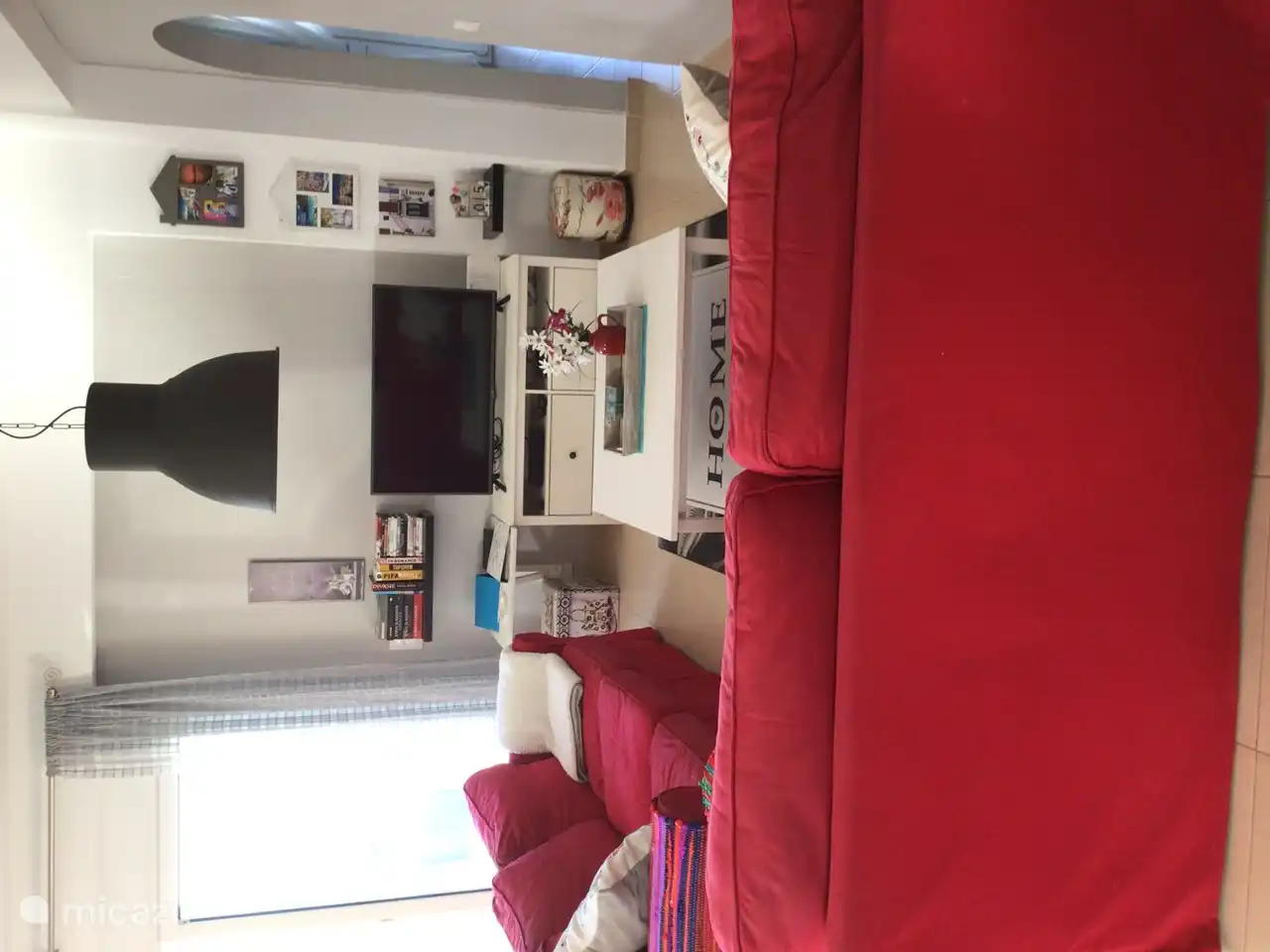 Sitting area with two and three seater sofa, coffee tables and TV cabinet.