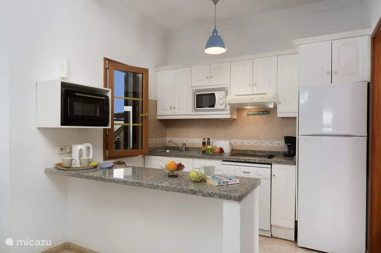 our open kitchen with oven, microwave and dishwasher.
