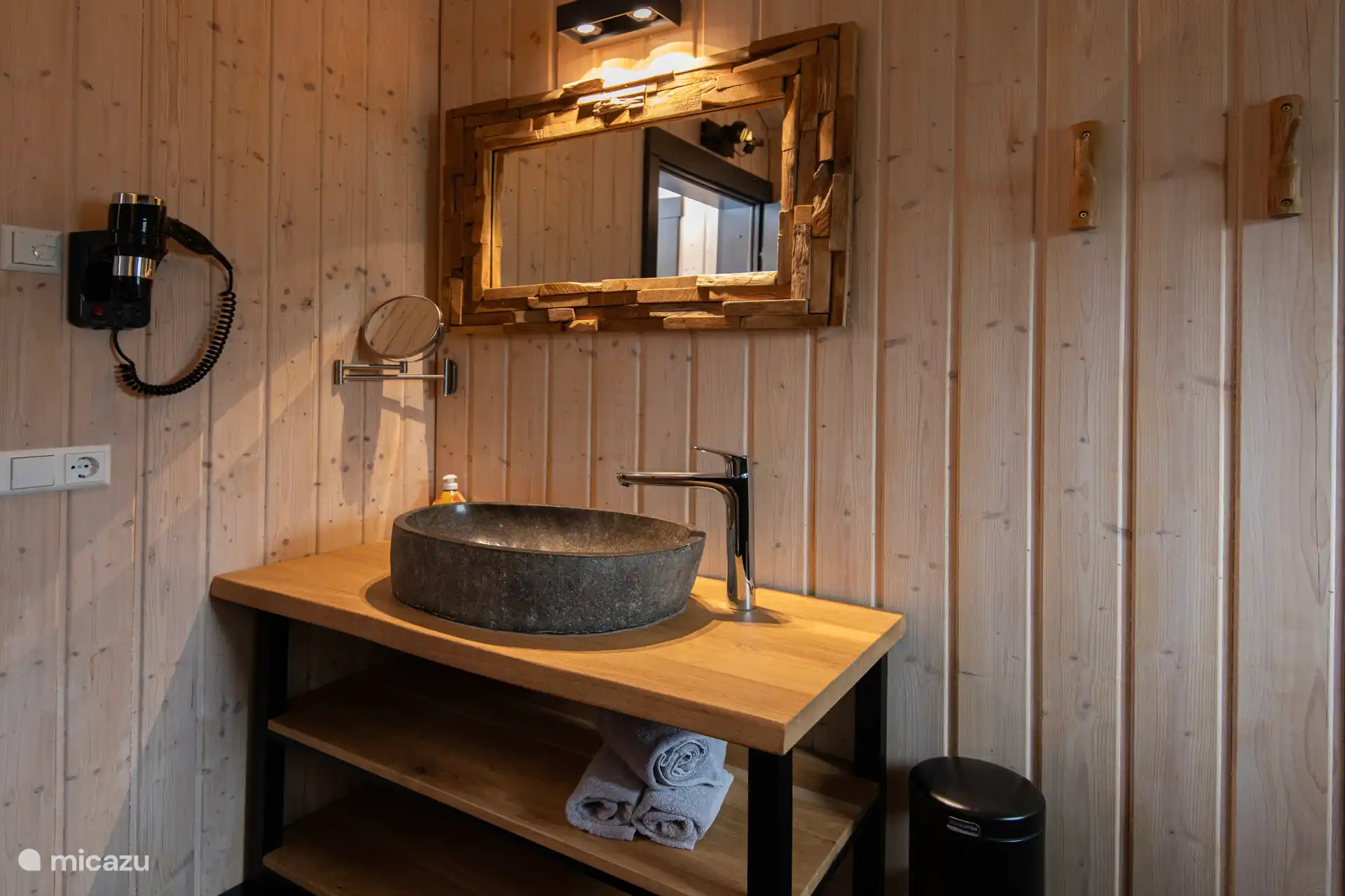 Waschbecken im Badezimmer mit Föhn.
Beide Badezimmer sind identisch mit Dusche, Toilette und Waschbecken.  