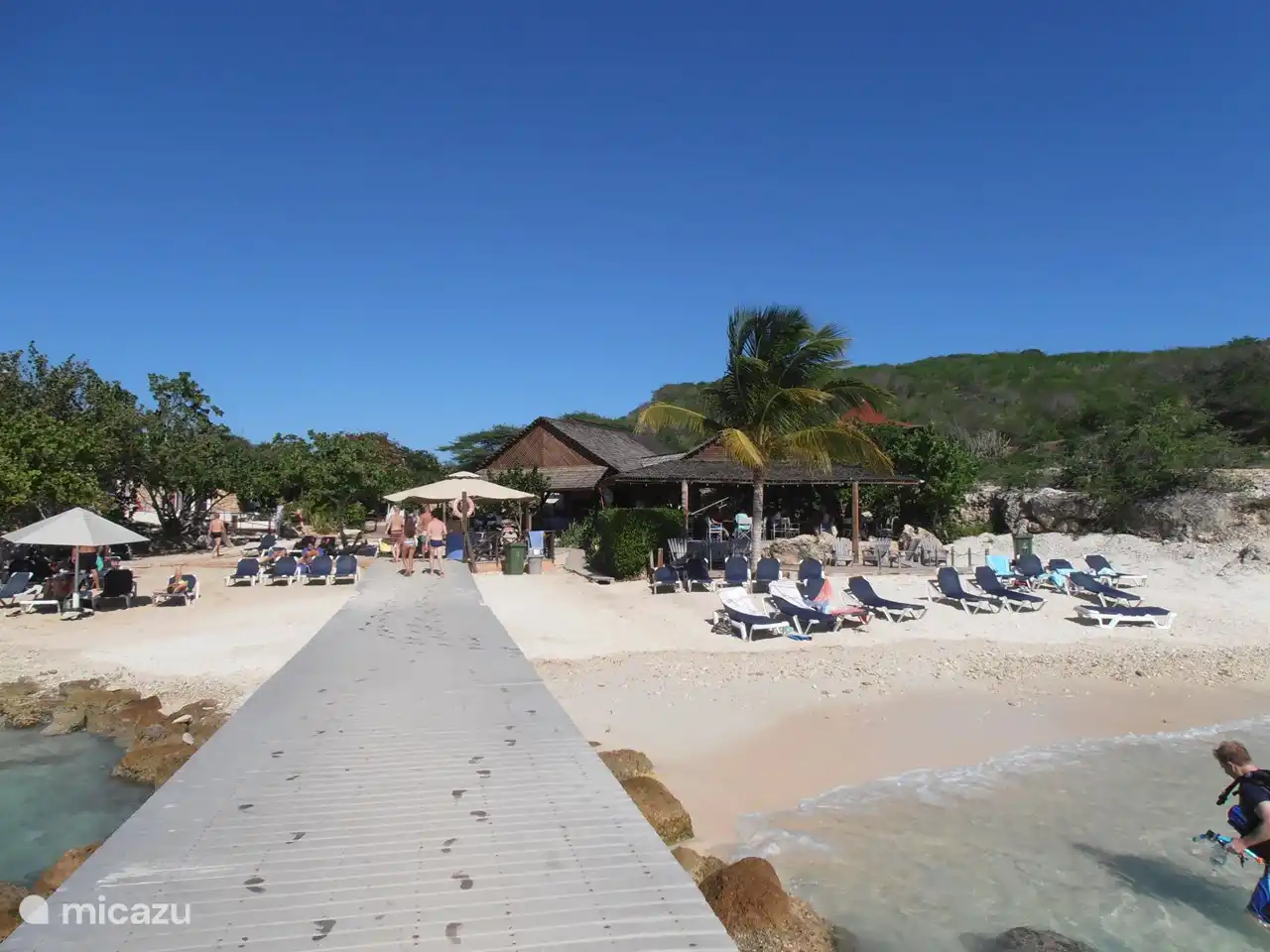 En el hermoso chiringuito en la playa de Porto Mari puedes tomar un buen almuerzo, una copa o un cóctel caribeño.