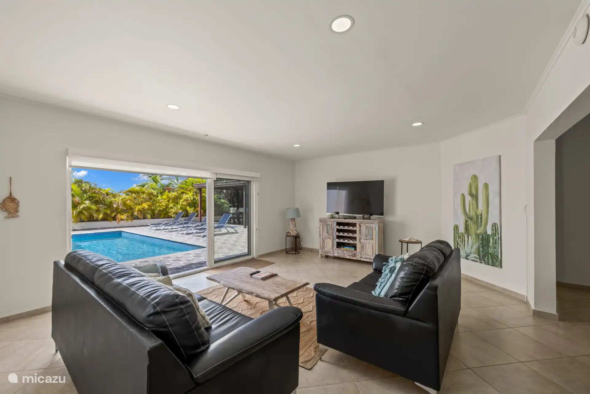 Salon spacieux avec de grandes portes coulissantes donnant sur l’extérieur.