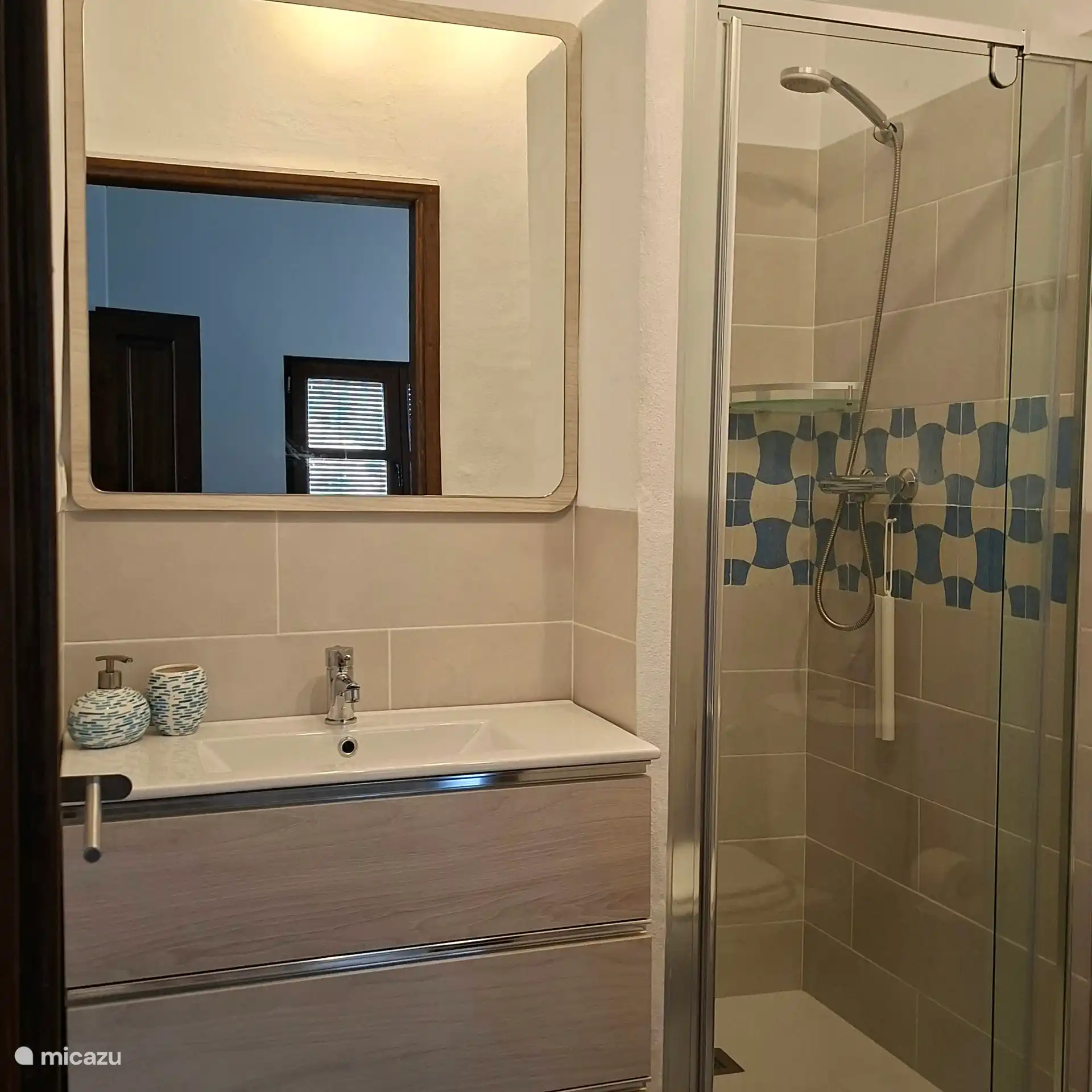 En suite badkamer met wastafel, toilet, föhn en douche.
Alle handdoeken aanwezig