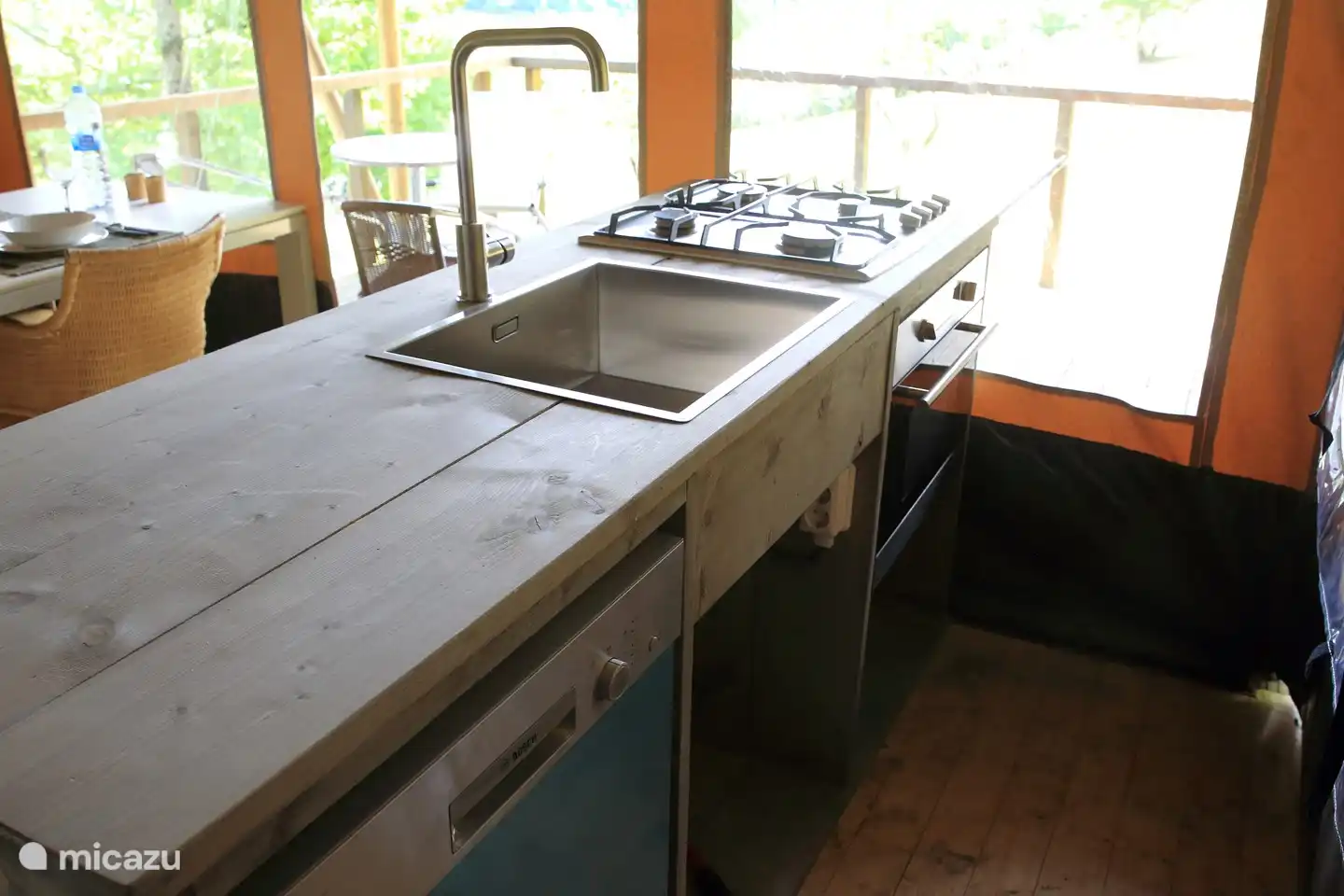 The kitchen with dishwasher and oven.