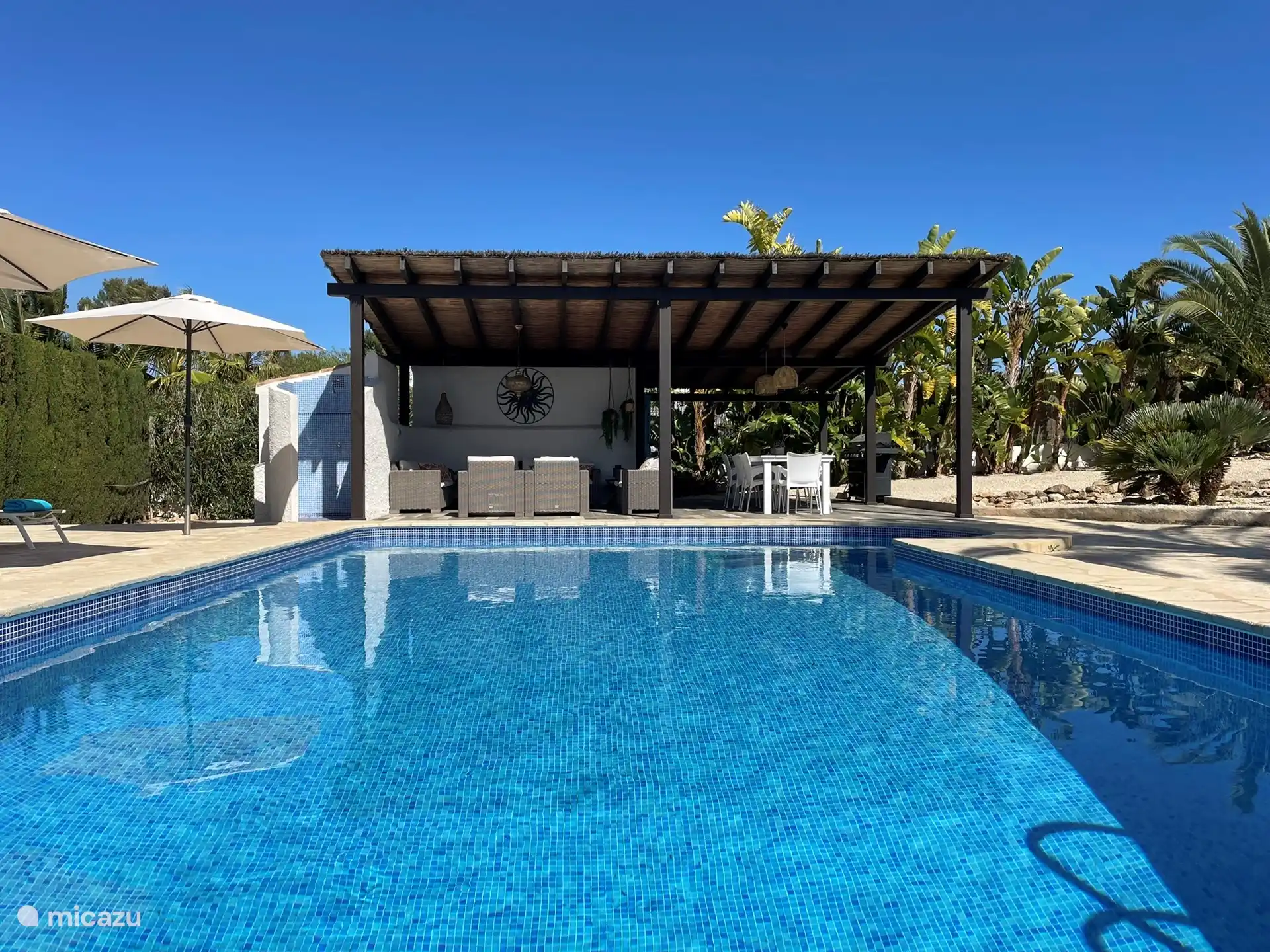 Cabana with outdoor shower. Behind the shower is a separate toilet.