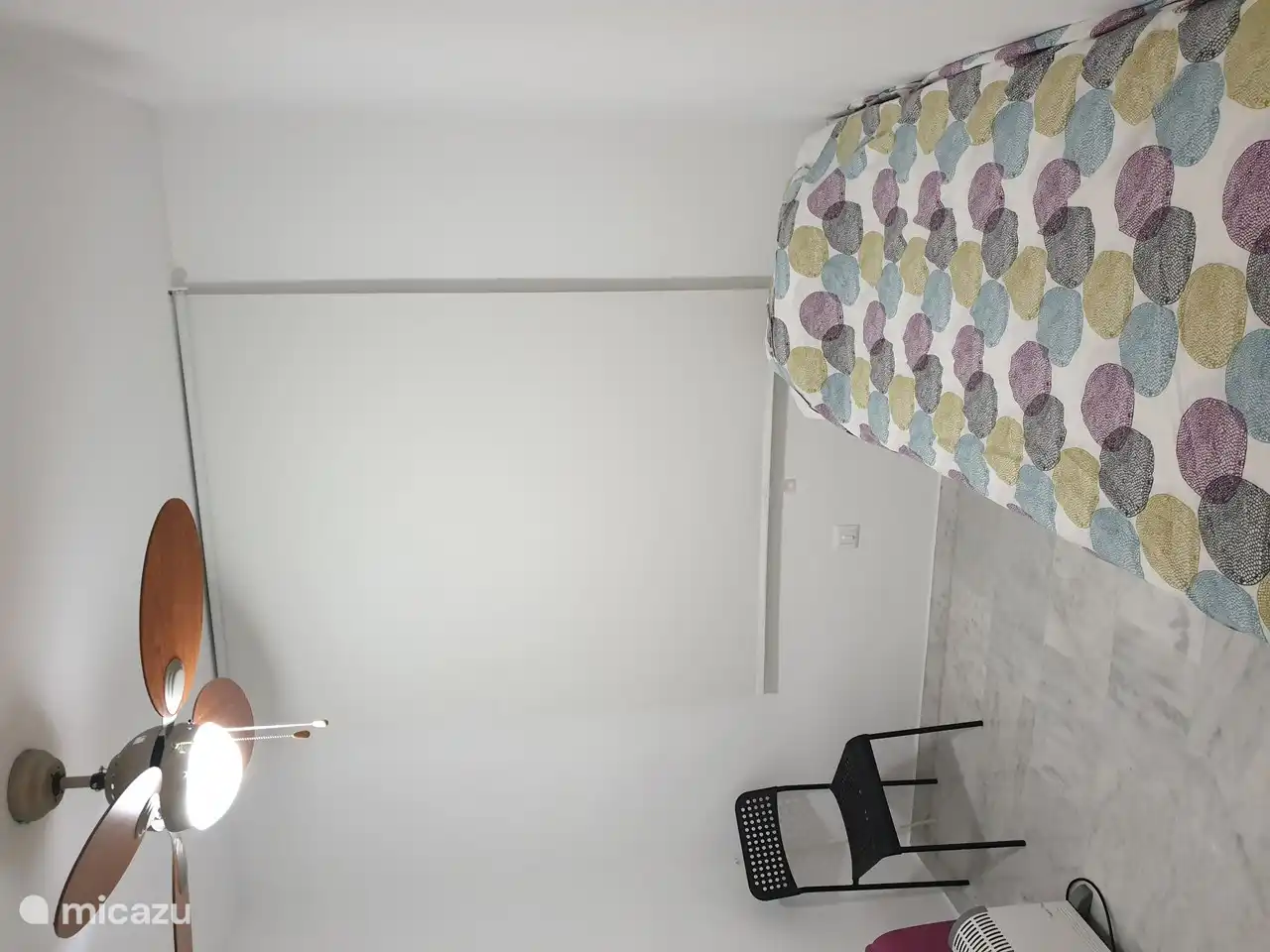 Small bedroom with pull-out bed and ceiling fan