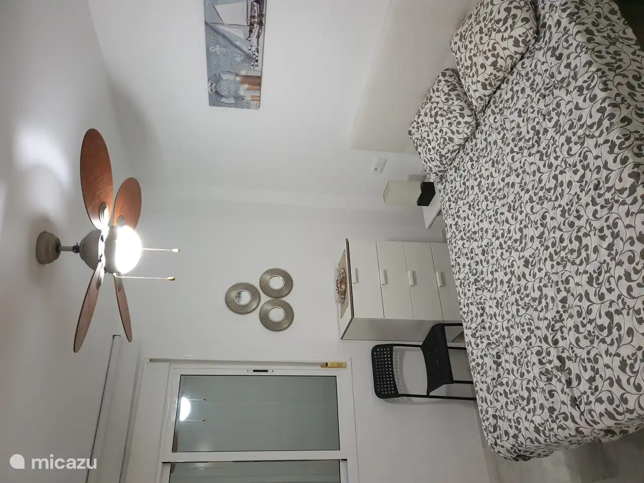 Large bedroom with ceiling fan and air conditioning