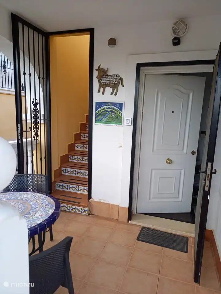 terraza cubierta con escaleras a la azotea y entrada a la planta superior