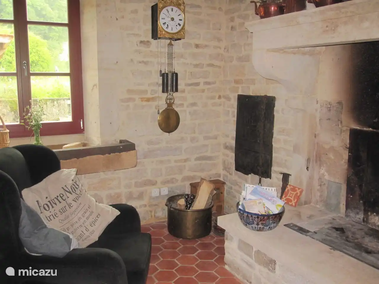Seat in kitchen with fireplace.