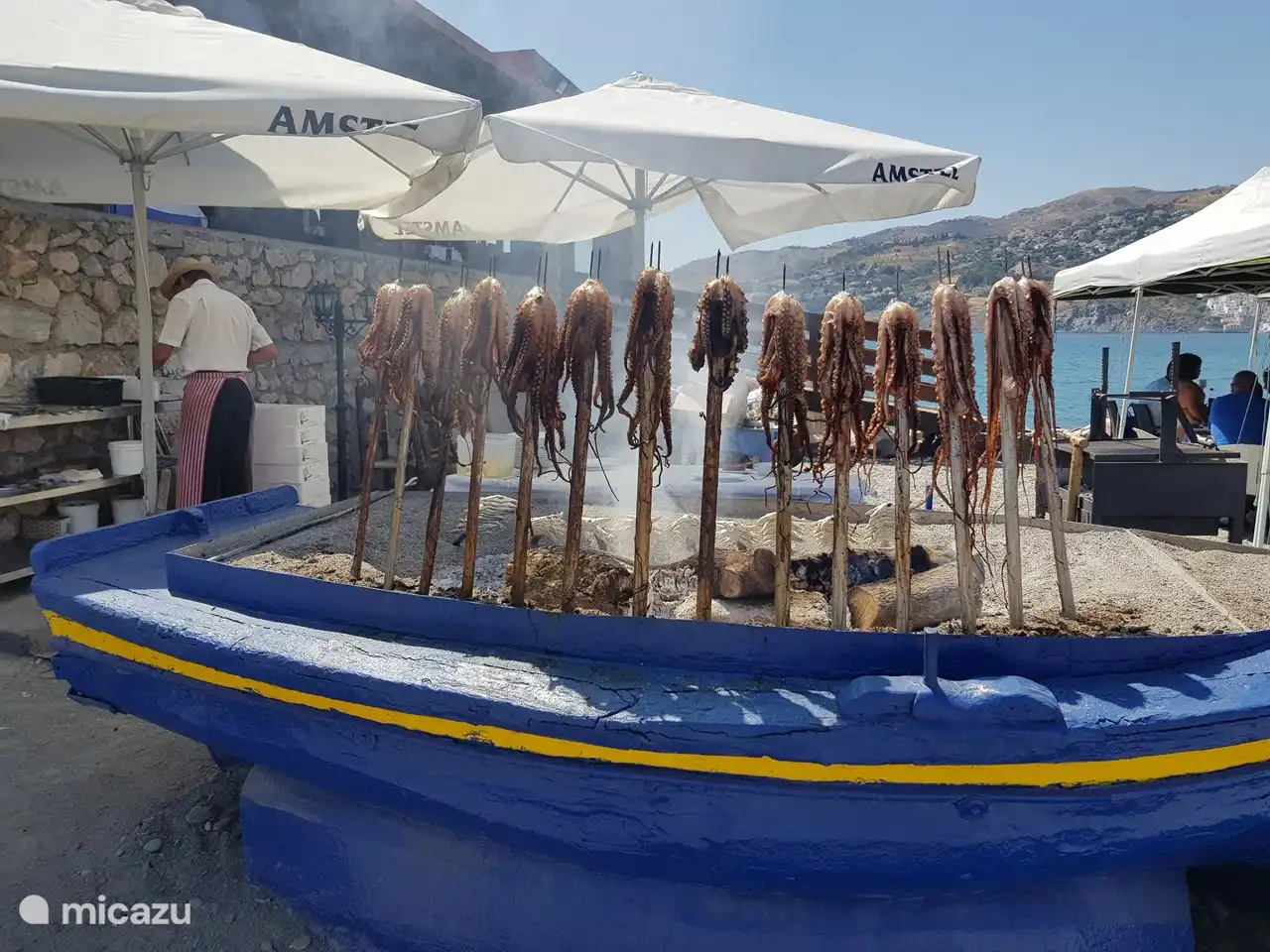fresh food is prepared on the beach, on coal in boats. not only nice to see, but also delicious.