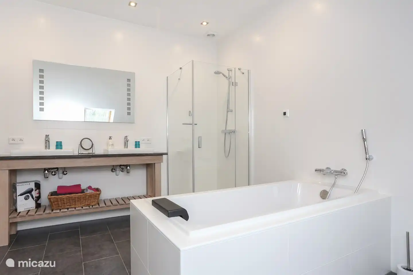 Zweites Badezimmer ebenfalls mit Badewanne und Dusche sowie Toilette und Doppelwaschbecken