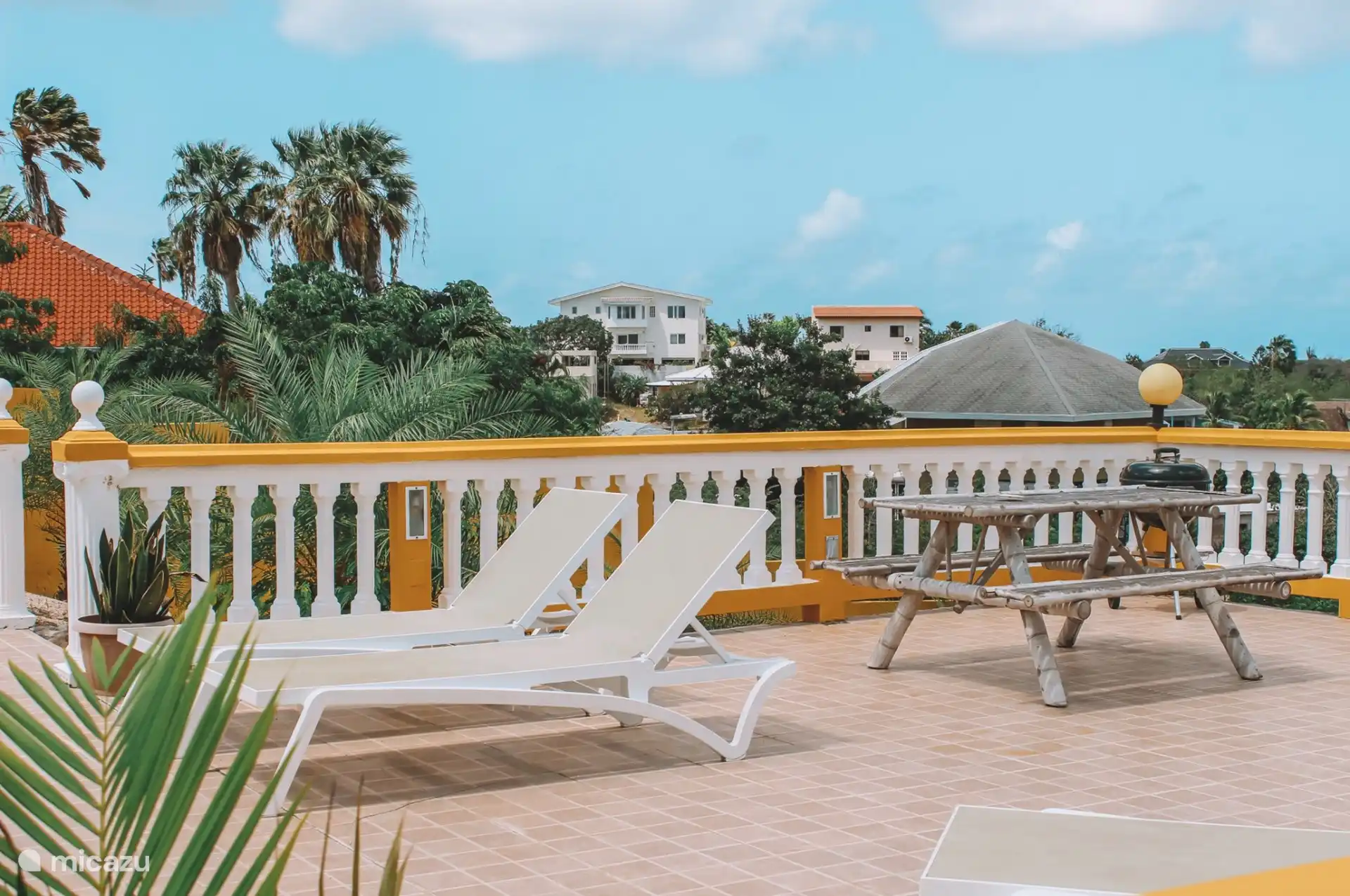 La terrasse commune avec BBQ et divers salons/coins salons.