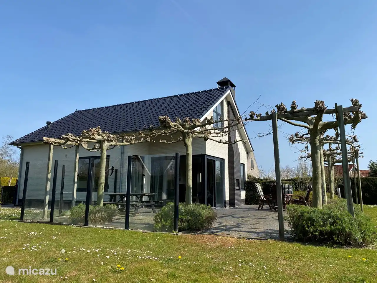 Haus mit geräumiger Terrasse, vom Garten aus gesehen