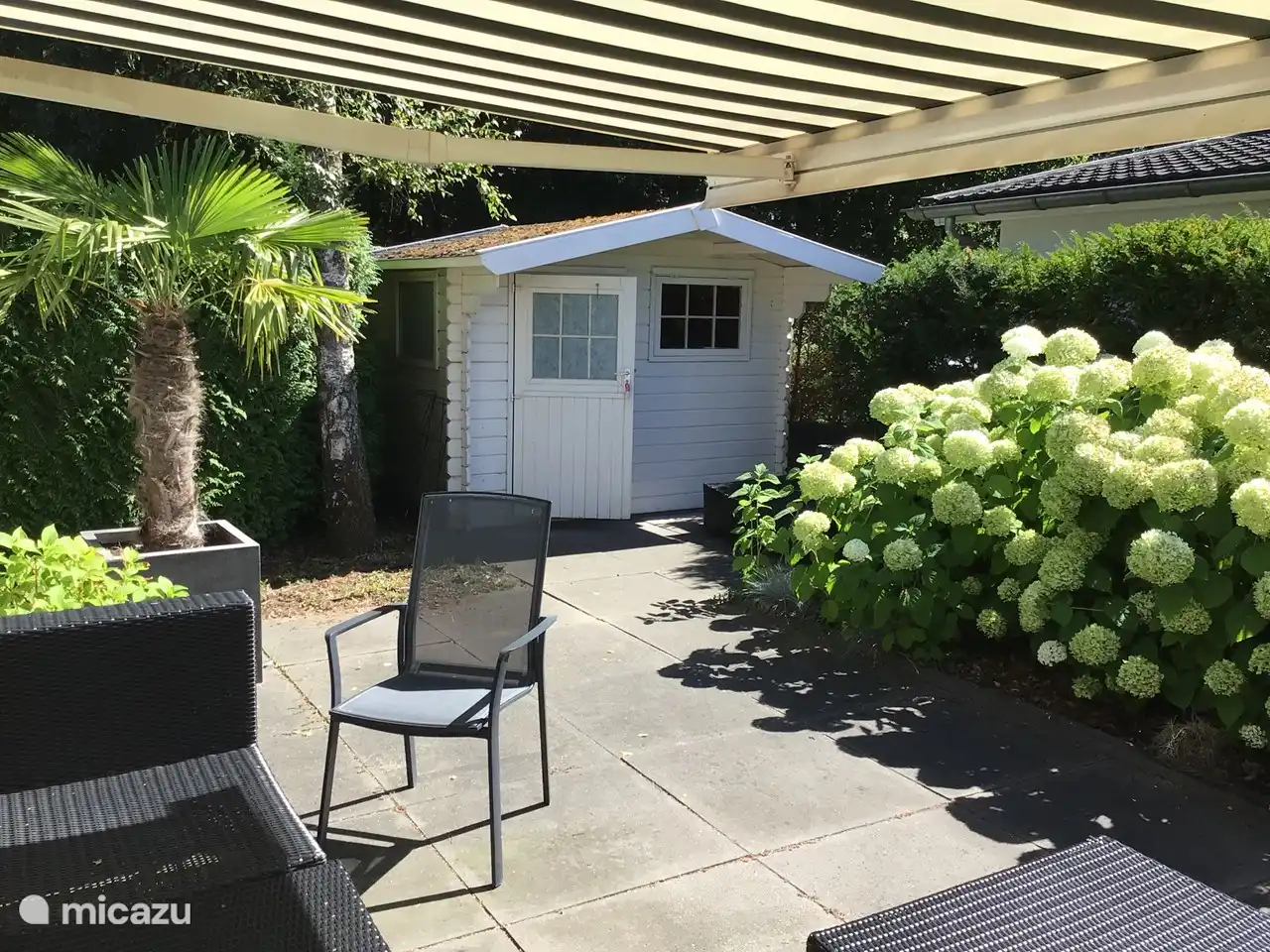Terrace on the east side with a large fixed movable awning 