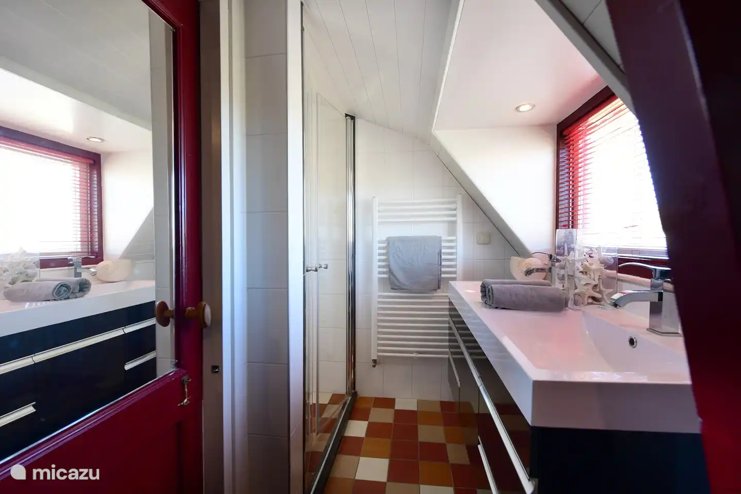 Bathroom with double sink and walk-in shower