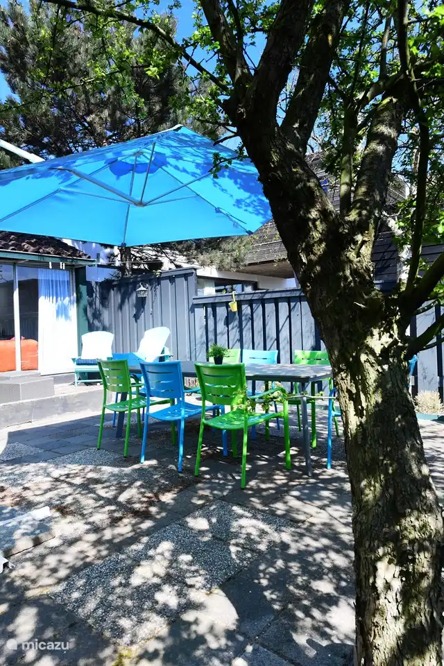 Garden with large dining table and parasol
