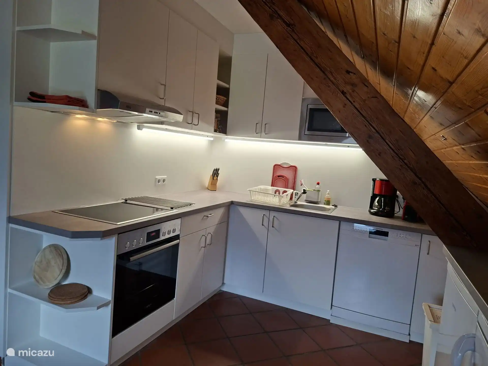 New kitchen with hob, oven, microwave, coffee maker, Nespresso machine, hot water kettle, toaster, two fridges (one with freezer) and dishwasher.