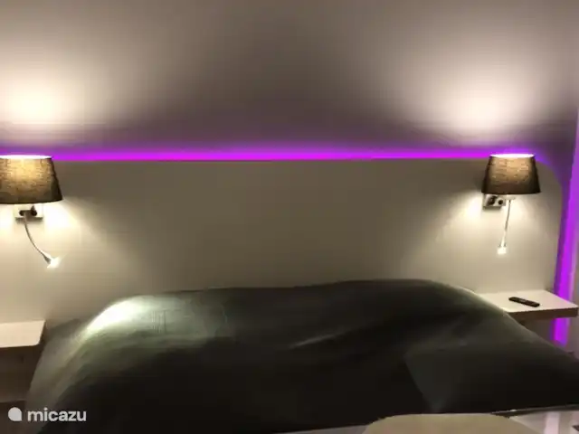 Smit France | France, Côte d'Azur, Sainte-Maxime - maison de vacances Chambre 3 (arrière de la maison) avec placard et éclairage LED coloré derrière le lit. Lampe de chevet et lampe de lecture séparée