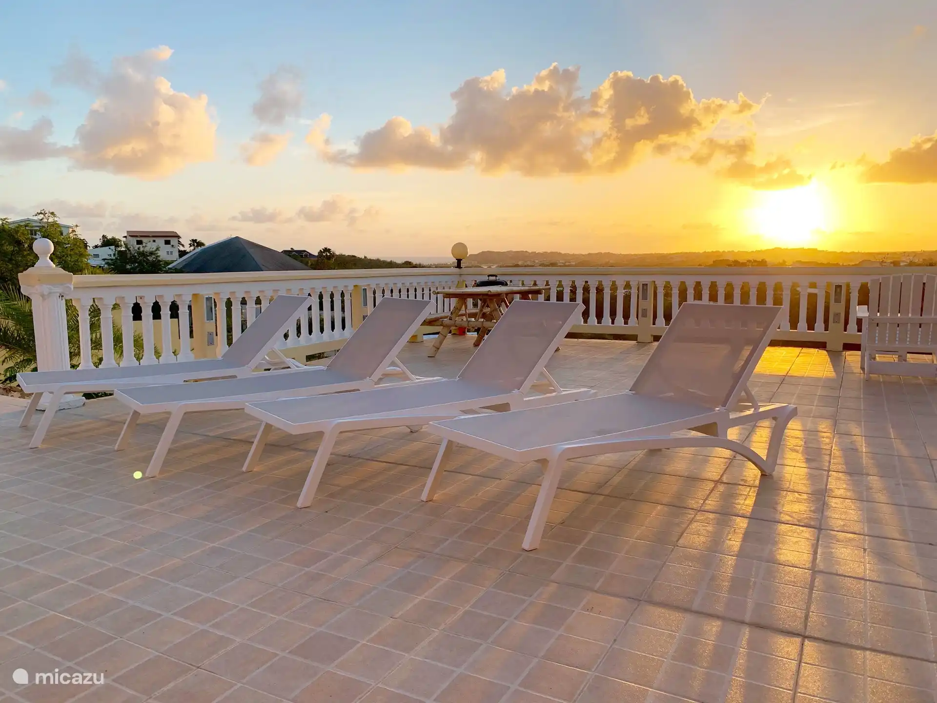 La terrasse commune avec BBQ et divers salons/coins salons.