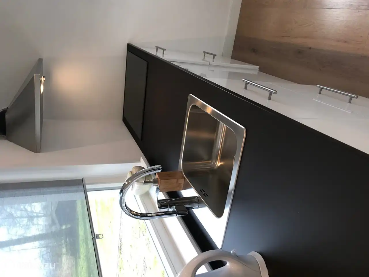 kitchen with dishwasher, induction hob, oven, fridge with freezer and Nespresso coffee machine