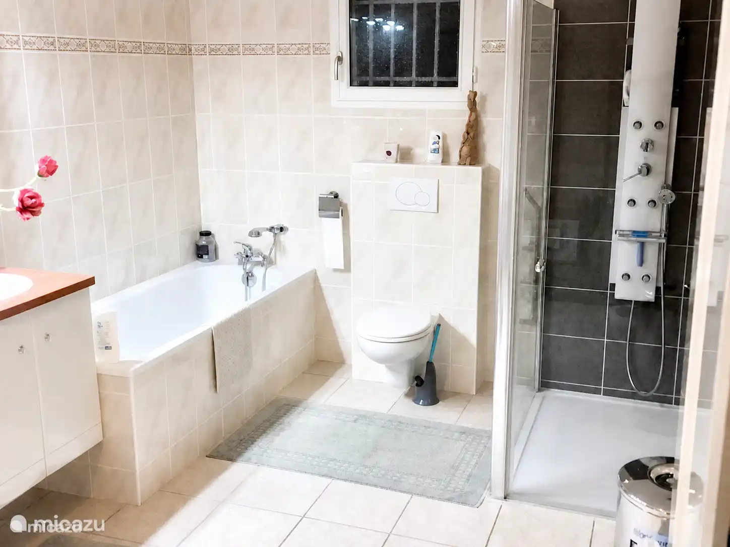 La grande salle de bain au rez-de-chaussée, accessible par le couloir et la chambre principale