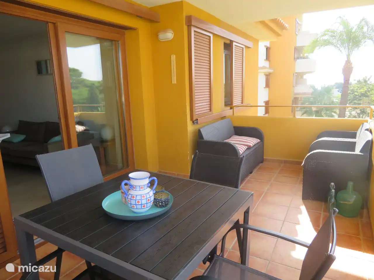 Sitting area on the balcony. There is sun from noon to sunset