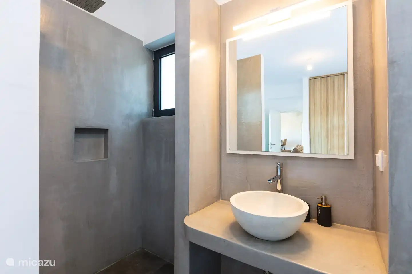 Das Gästezimmer verfügt über ein eigenes Badezimmer mit einer geräumigen ebenerdigen Dusche, Toilette und Waschbecken.