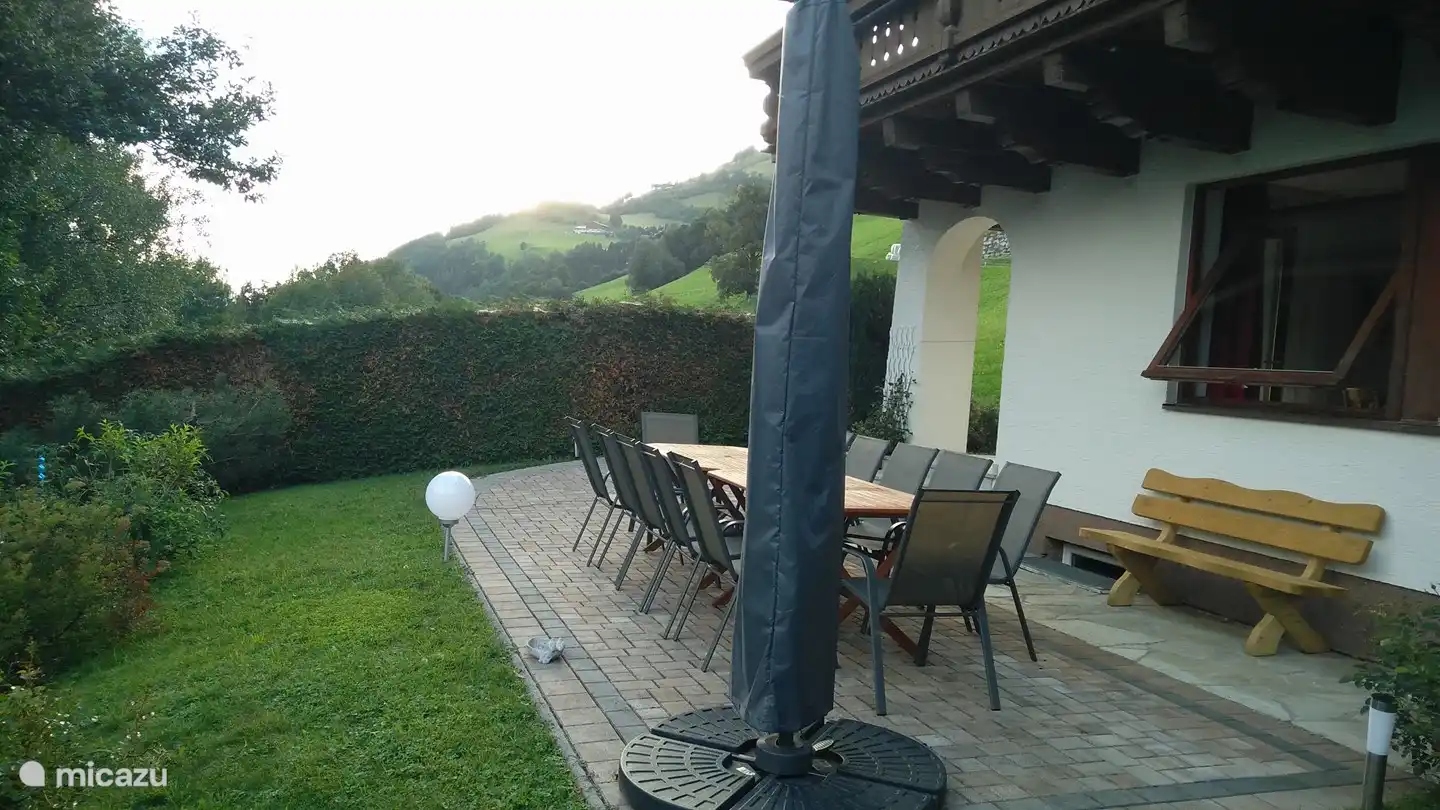 Backyard and terrace with seating and parasol