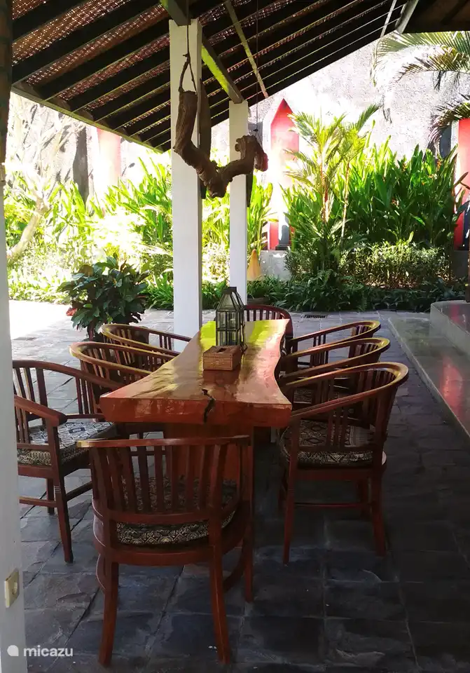 Gran mesa de madera para 8 personas en la terraza contigua al salón