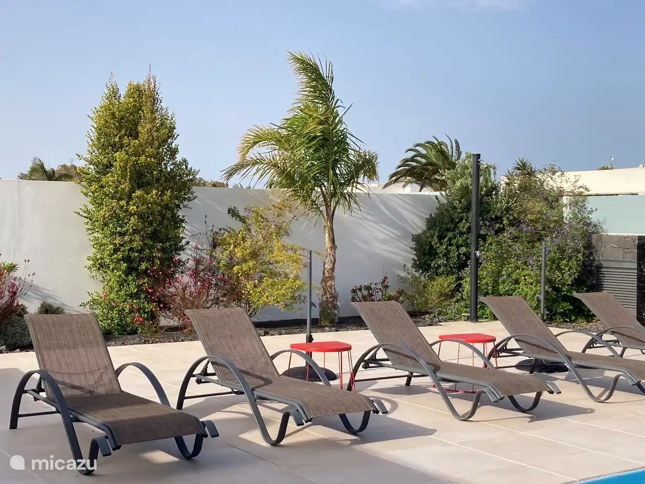5 sun loungers along the pool.