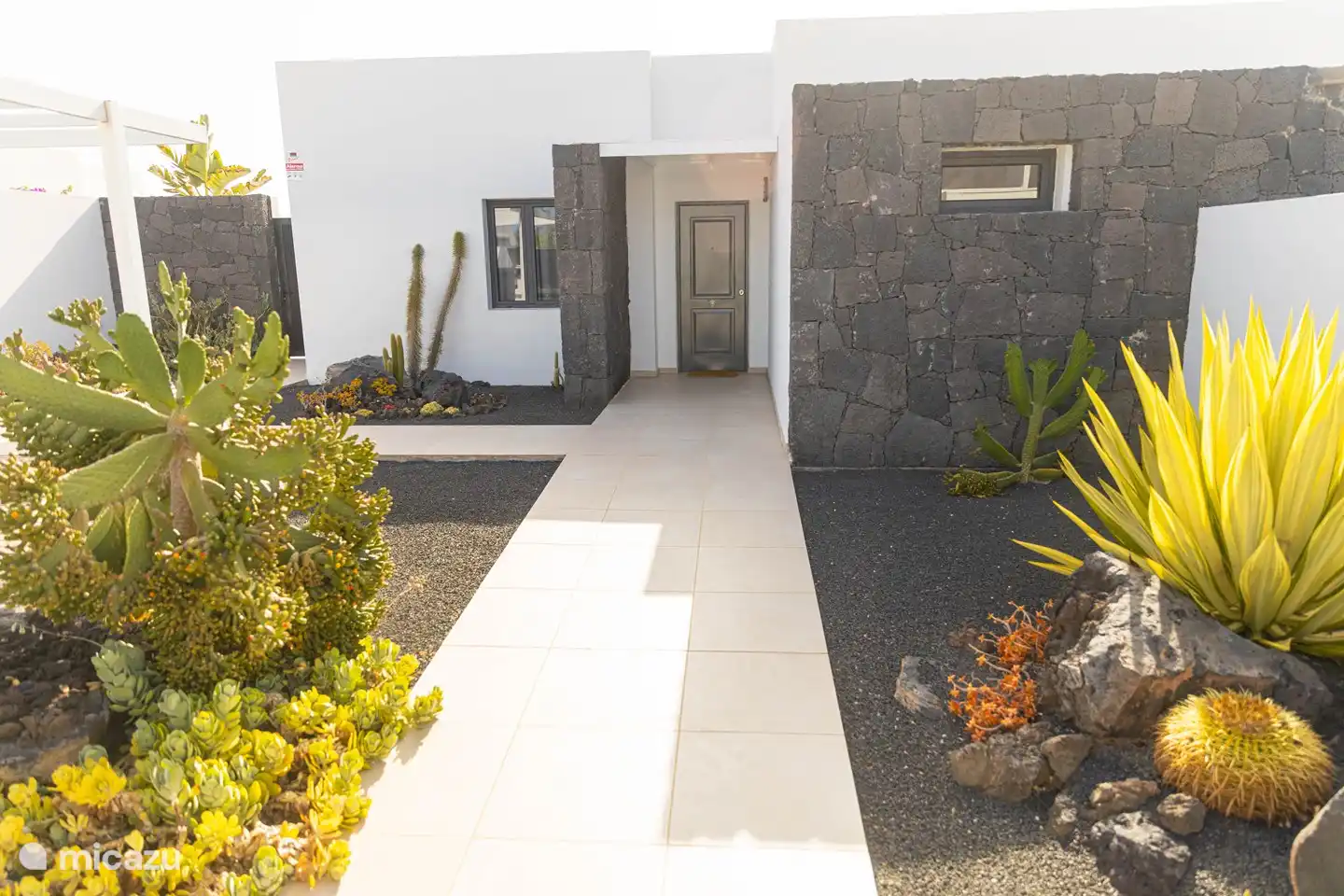 Front of the house. It is always nice to arrive at the beautiful cactus and other plants in the garden. There is room to park your car on the left (not in the photo).