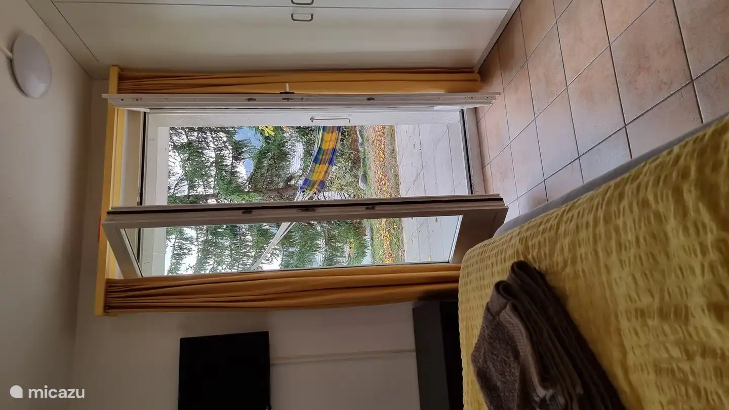 master bedroom with TV and patio doors to terrace