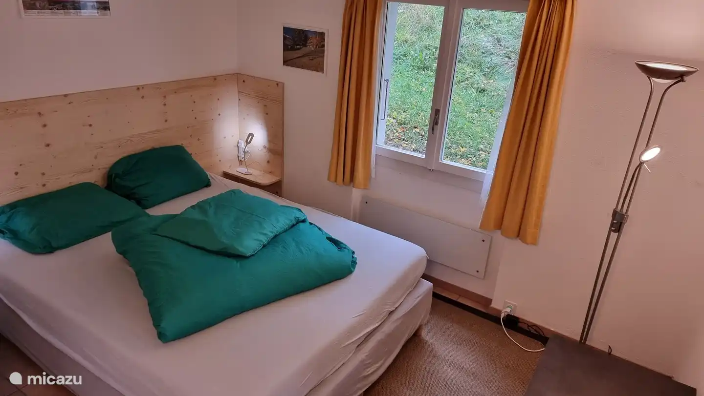 master bedroom with TV and patio doors to terrace