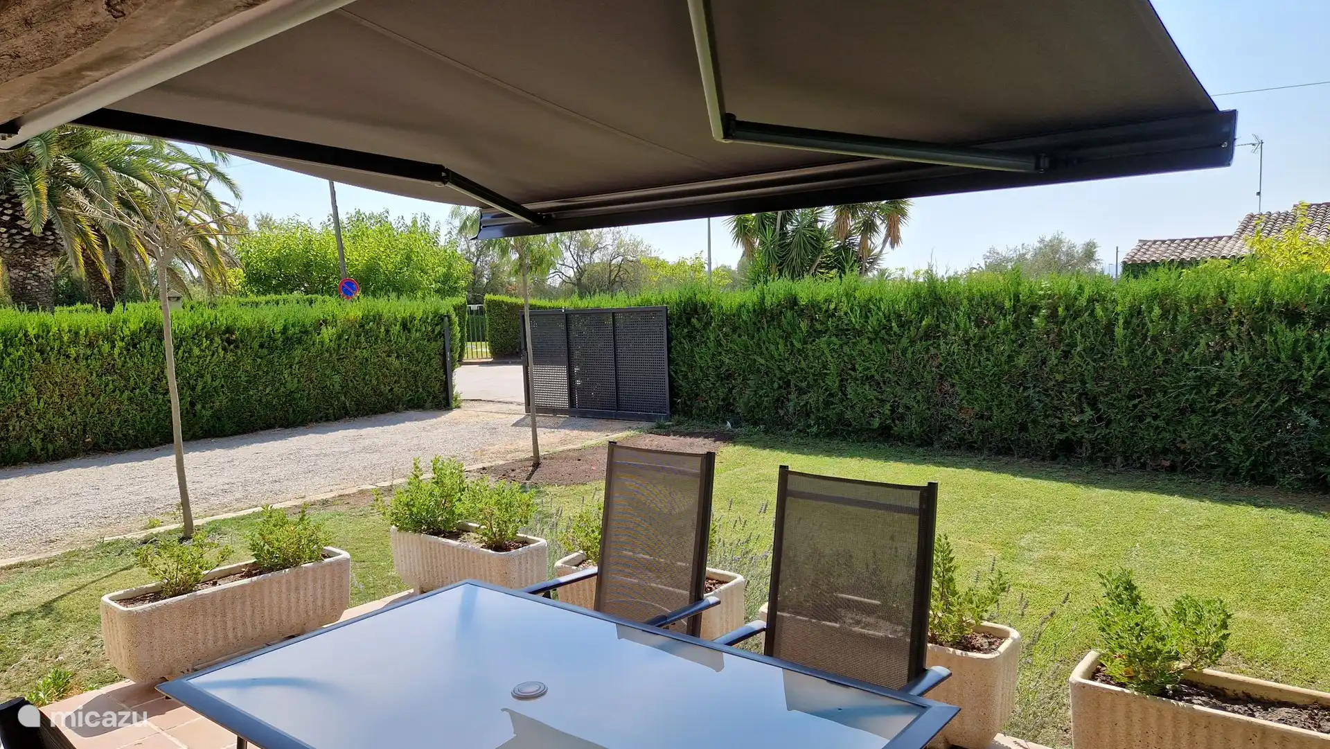 Terrace with electric awning and garden