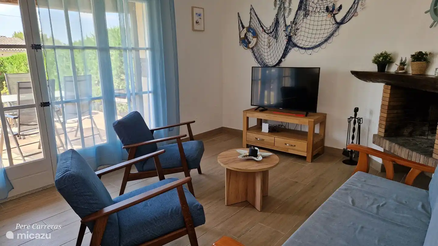 Living room with sofa and armchair. Smart TV 43 