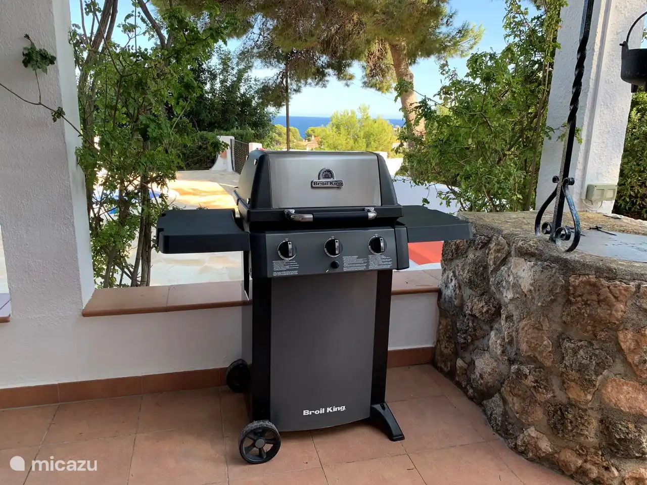 mobile BBQ placed here next to the dining table on the terrace