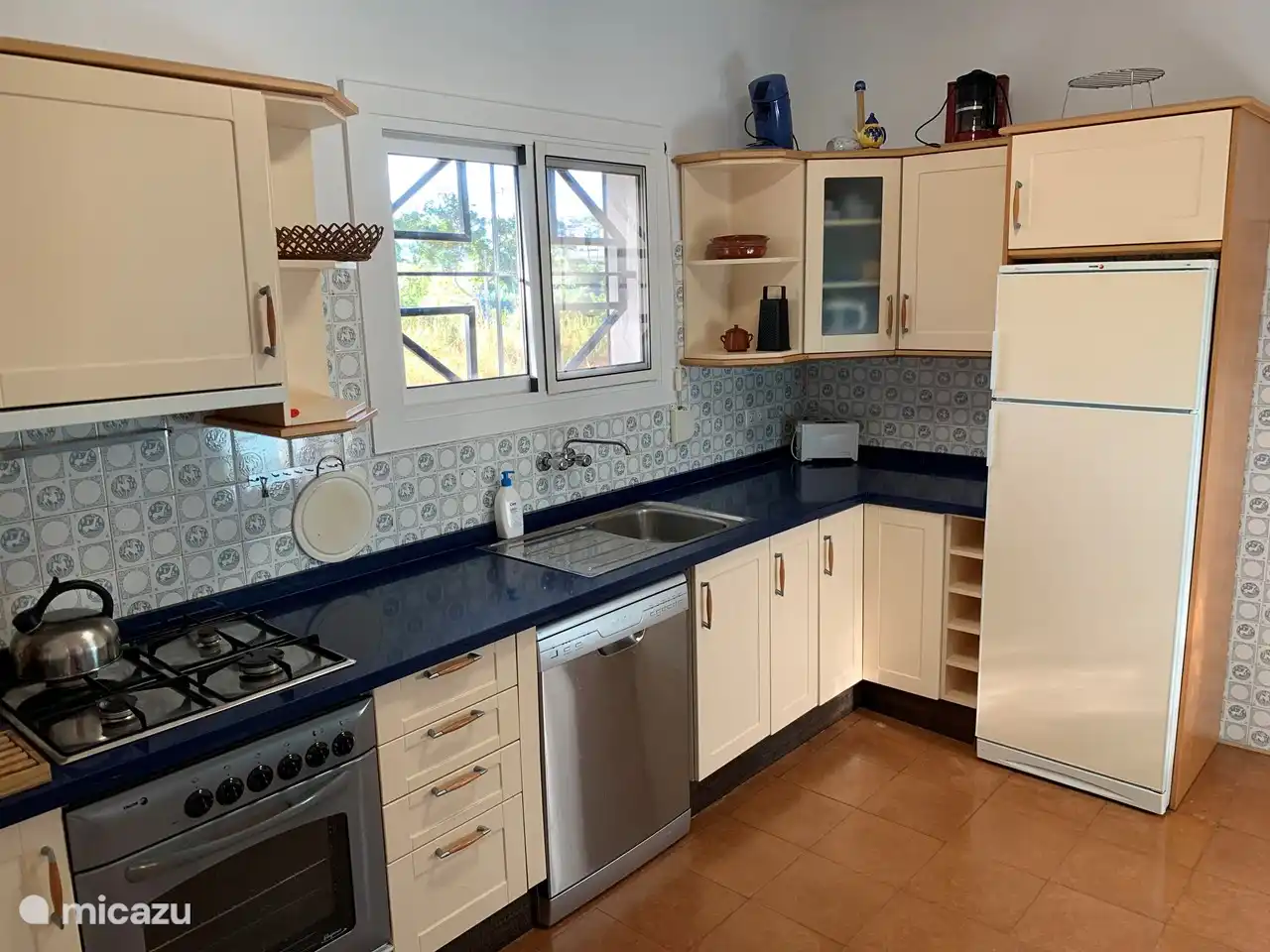 Kitchen from living room entrance (so has 2 entrances) with built-in appliances, gas stove and refrigerator replaced in 2021
