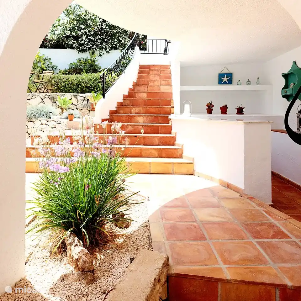 Die Sommerbar mit der Treppe nach links zur großen Terrasse und Eingang zum Wohnzimmer.